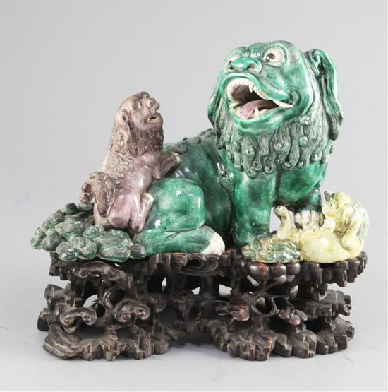 A Chinese famille verte glazed group of lions, 19th century, 23cm high, 25cm long, including fitted wood stand, smallest cub re-attache